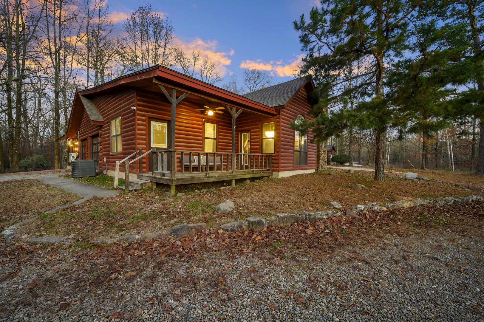 A rustic log cabin retreat nestled among towering trees, offering a perfect woodland escape with warm lighting and private deck.