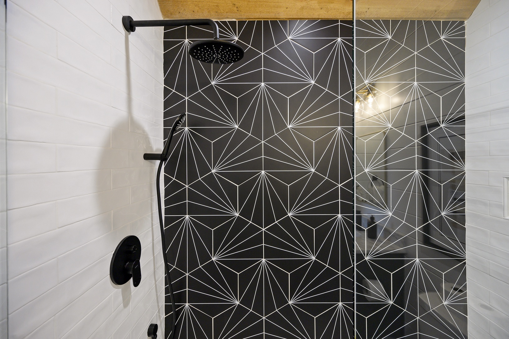 Step into your private spa-like shower with stunning geometric tilework and rainfall showerhead for the perfect morning ritual.