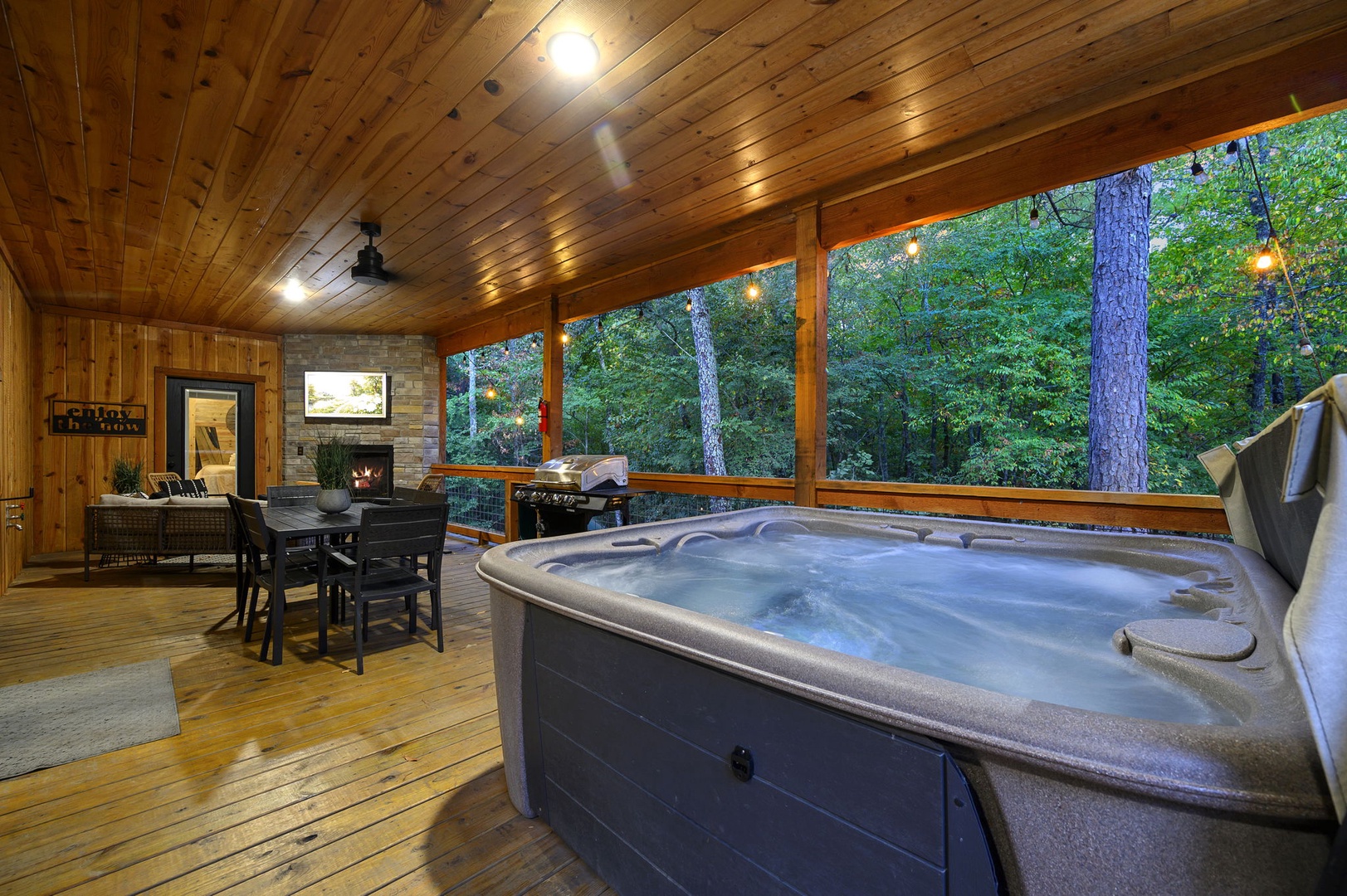 Unwind in your private hot tub with forest views all around, then gather at the outdoor dining table or fire up the grill for an evening under the trees.