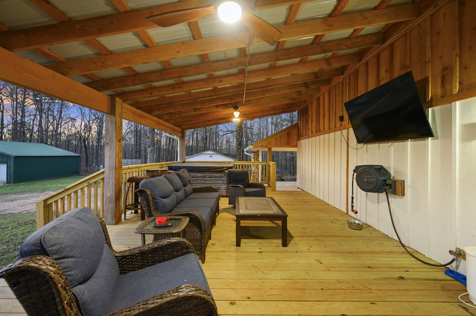 Relax on your private covered deck with cozy seating, TV entertainment, and hot tub - your perfect retreat after exploring.