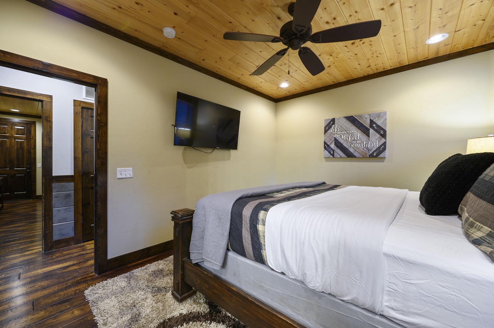 Unwind in your private bedroom with rustic wood-beam ceilings, a plush bed, and a ceiling fan to keep you comfortable. The TV is ready for your favorite shows.