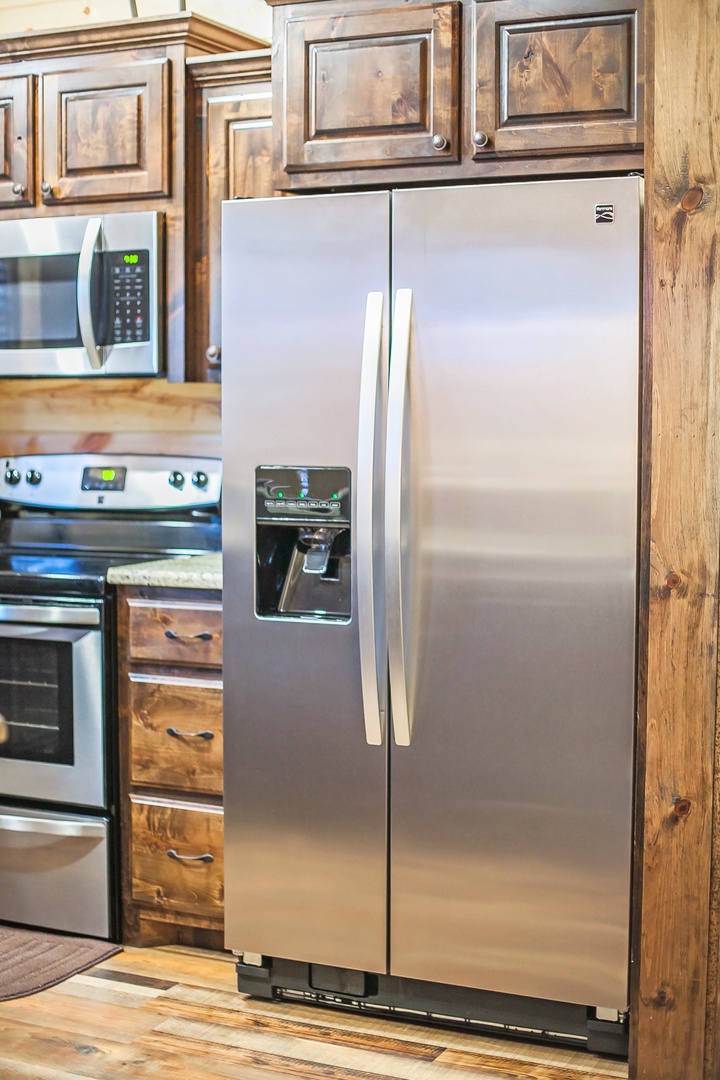 Your fully equipped kitchen features stainless steel appliances and rustic wood cabinetry, perfect for preparing meals during your stay.