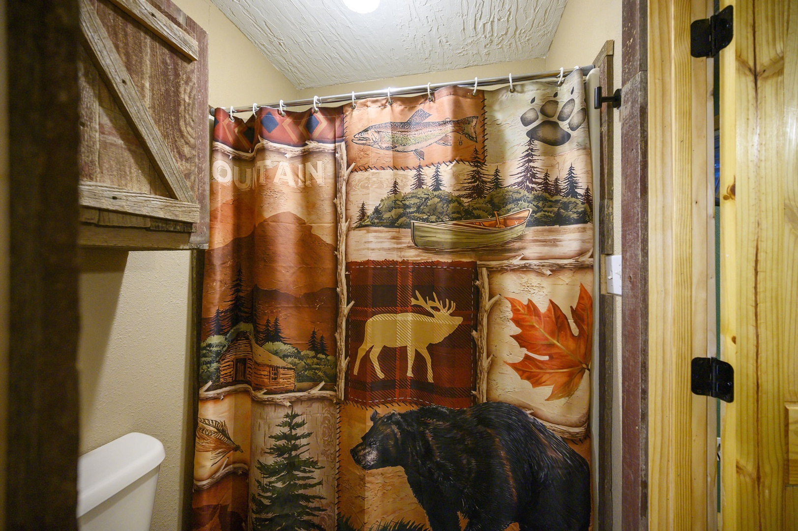 Your rustic bathroom features charming wilderness-themed décor with cozy cabin touches that make you feel at one with nature.