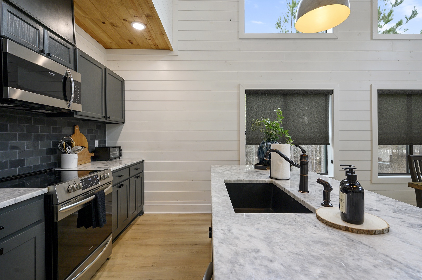 Your gourmet kitchen features gleaming marble countertops, modern appliances, and charming skylights that fill the space with natural light for memorable meals.