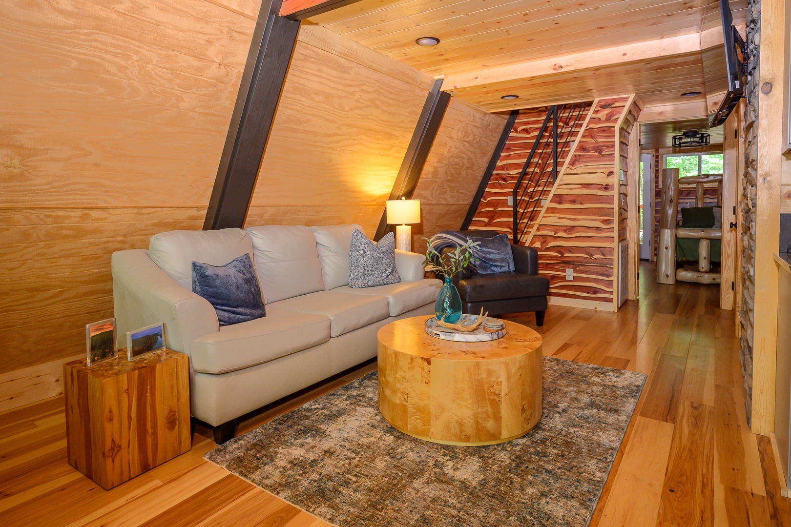 Settle into this cozy living space with warm wood tones and thoughtful touches. Soft lighting and comfortable seating invite you to relax after your day of exploring.