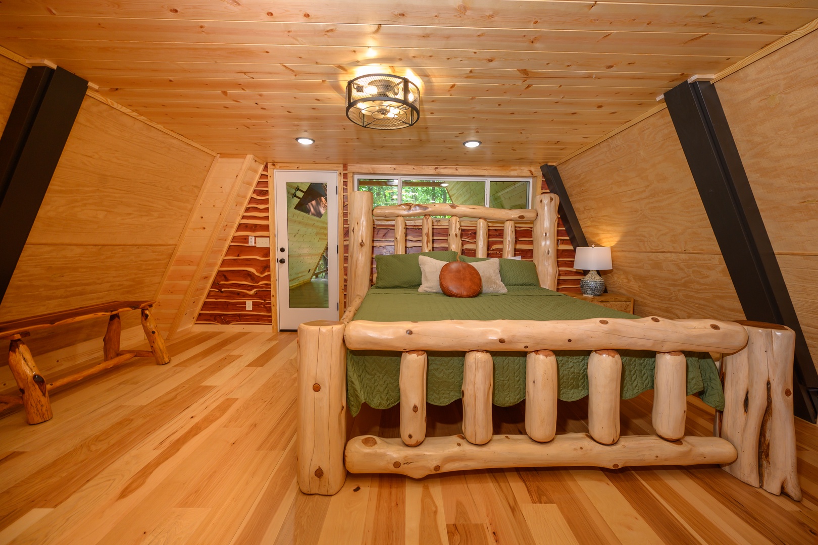 Unwind in your cozy cabin-style bedroom featuring handcrafted log furniture and warm pine finishes. The vaulted ceiling and natural wood create a peaceful retreat after your mountain adventures.