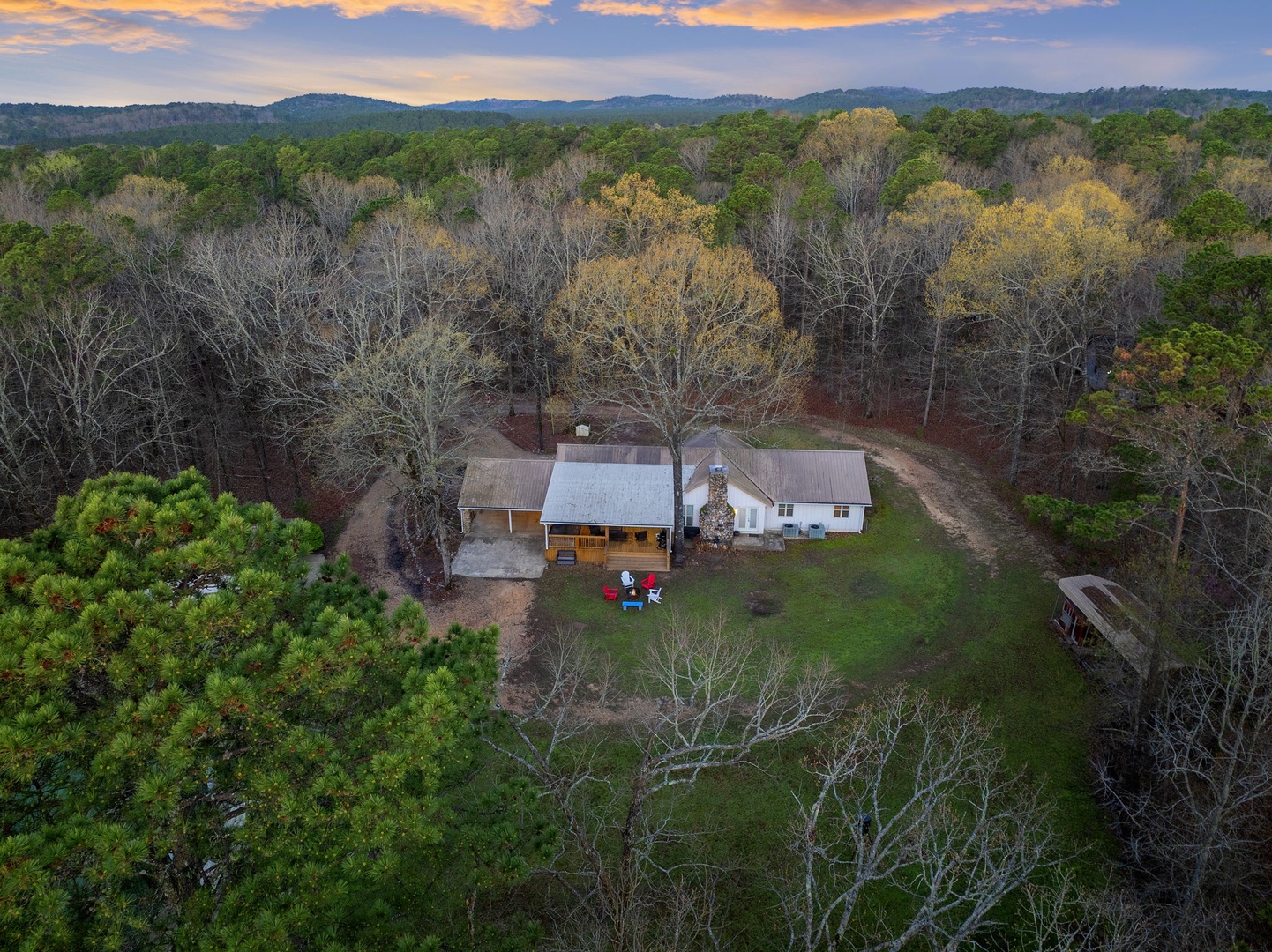 Peaceful farmhouse retreat nestled among rolling hills and mature hardwood forest, offering complete privacy and mountain valley views.