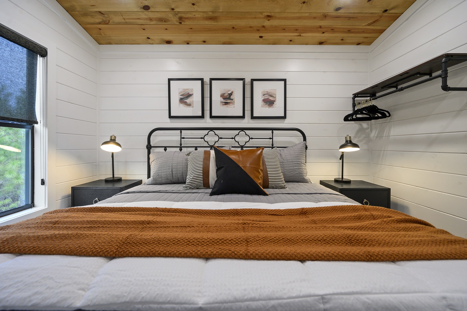 Drift off to sleep surrounded by rustic wood ceilings and modern comfort in this beautifully designed bedroom.