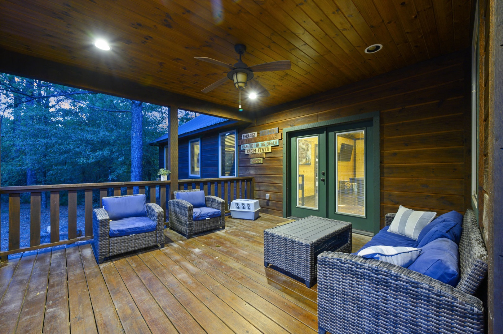 Settle into your private covered deck at twilight, where plush seating and forest views create the perfect retreat for starlit evenings.