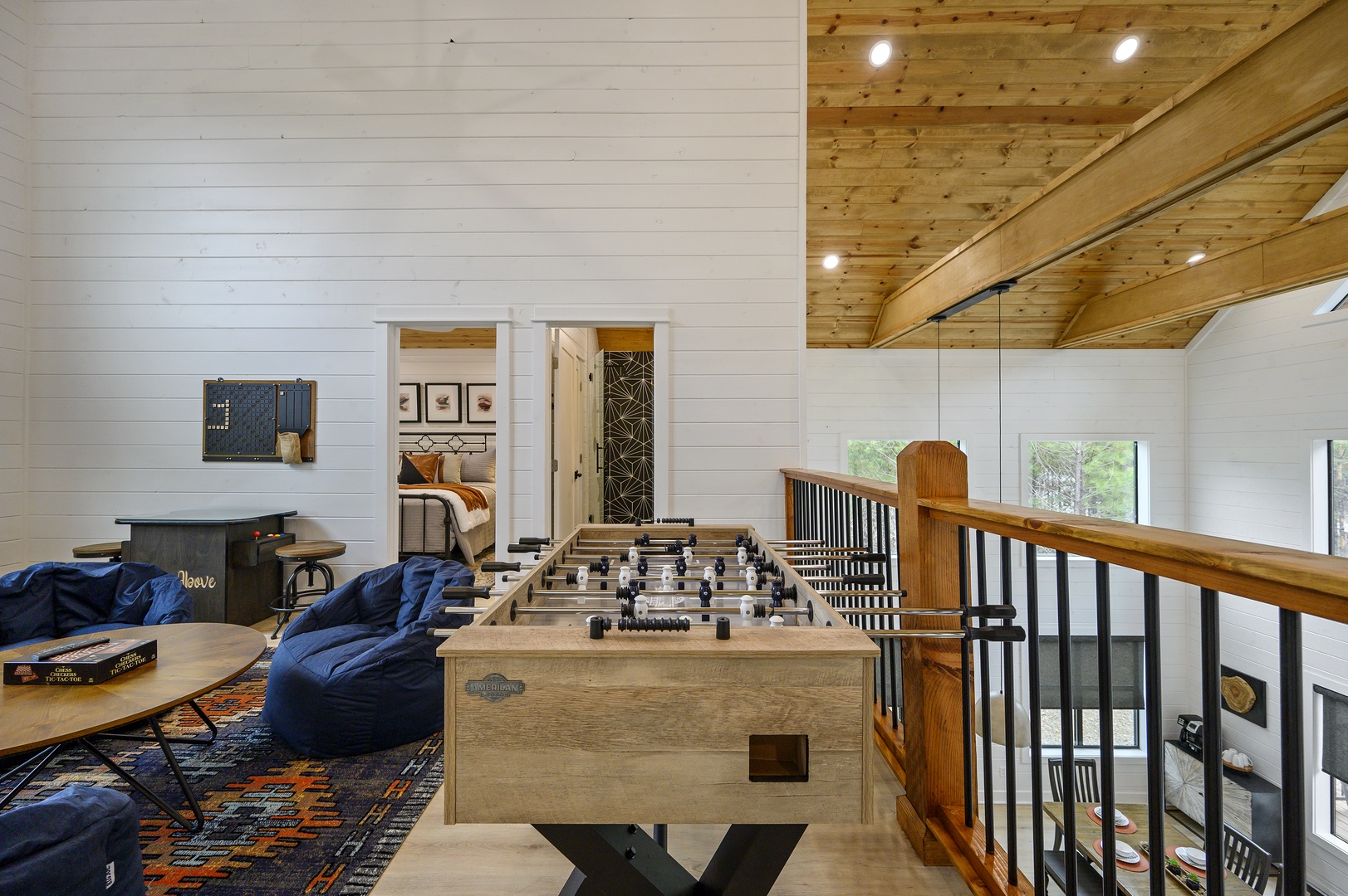Challenge friends to foosball in your spacious game loft, where rustic wood beams meet modern comfort for unforgettable evenings.