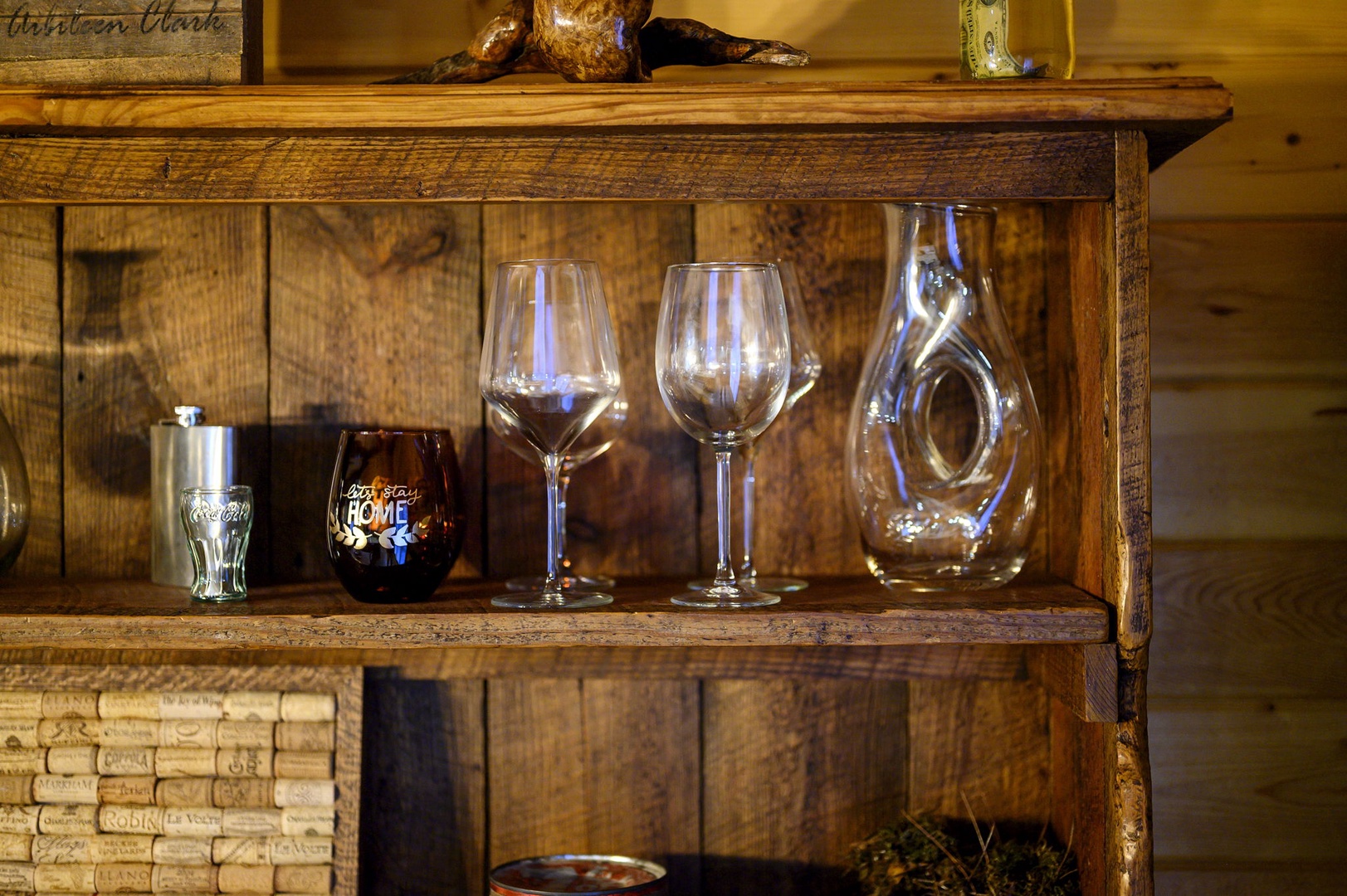 Raise a toast in your cozy retreat with elegant wine glasses and rustic charm perfectly arranged for memorable evenings.