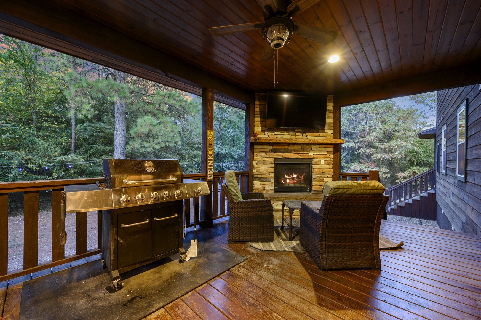 Cozy up by your private outdoor fireplace on your covered deck, where evenings glow with warmth. Grill your favorite meal while surrounded by peaceful wooded views, blending comfort and nature seamlessly.