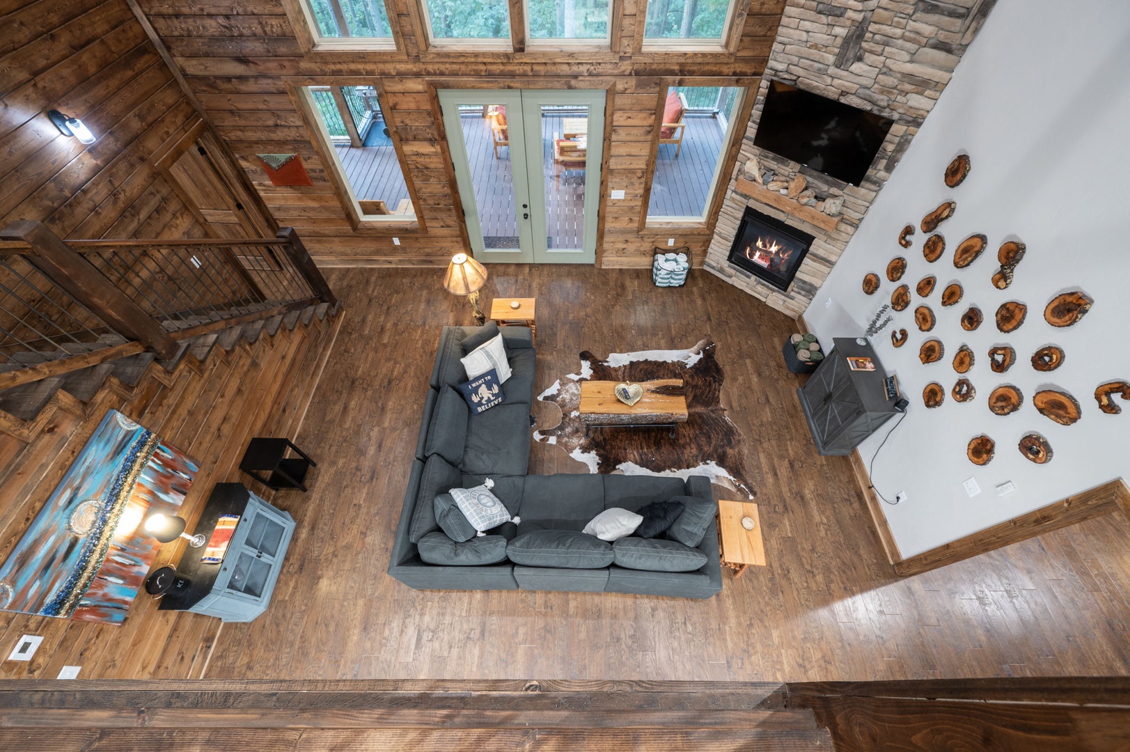 Soaring ceilings and natural light create your perfect mountain retreat, where rustic wood beams and a cozy stone fireplace invite you to unwind in style.