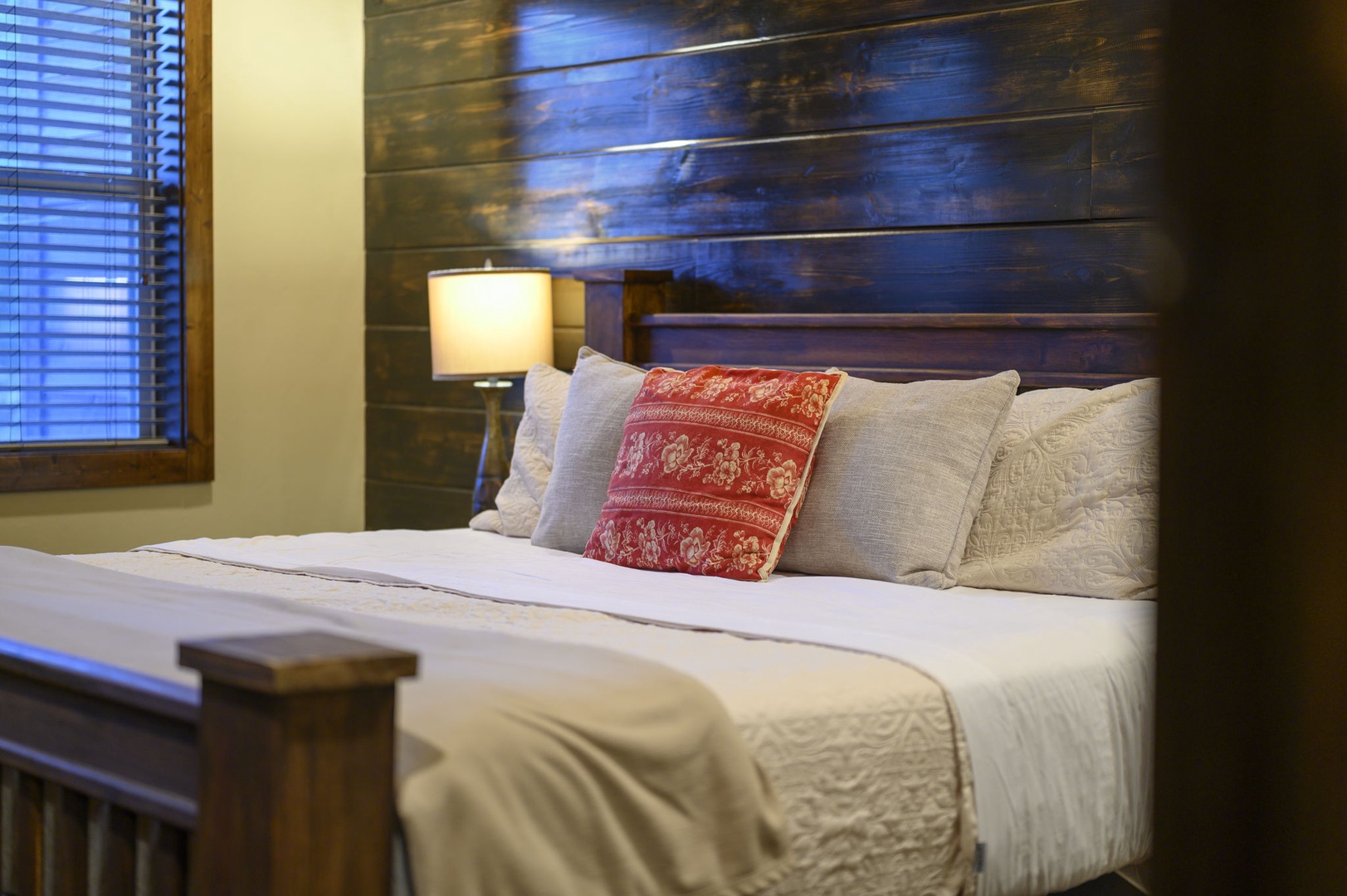 Sink into crisp white linens and plush pillows after a day of exploring. Your cozy retreat features rustic wood accents and warm lighting to help you unwind.
