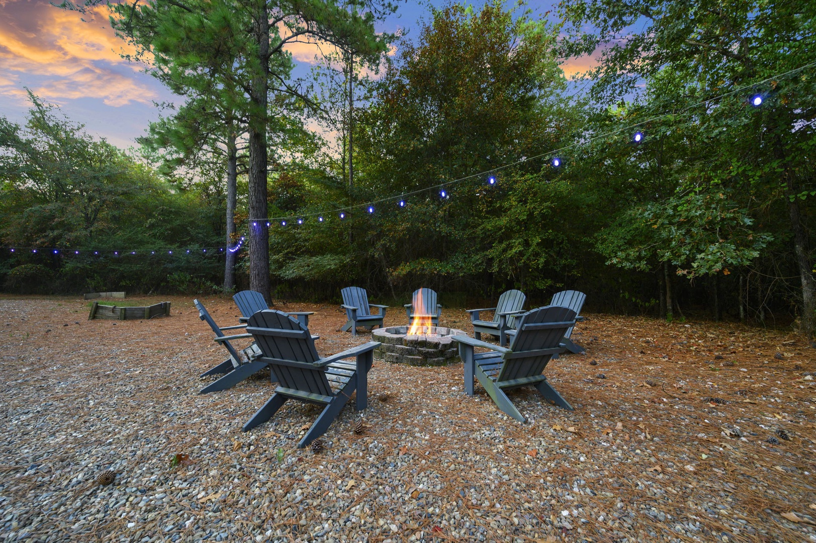 Picture yourself gathered around the crackling fire pit under soft string lights, swapping stories as dusk settles over the trees and the day melts into a peaceful evening.