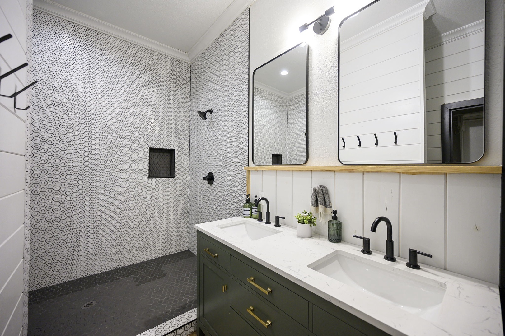 Unwind in your spa-like bathroom featuring dual sinks, beautiful patterned tile, and a spacious walk-in shower perfect for refreshing after your adventures.