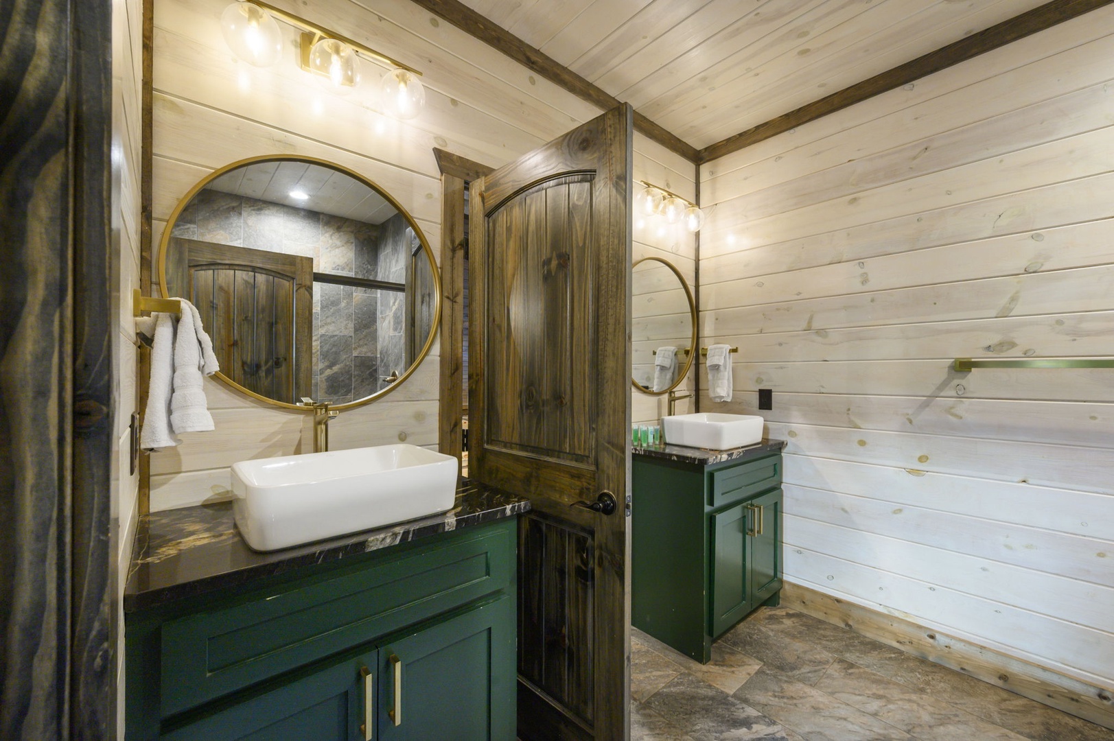 Step into your spa-like bathroom with dual vessel sinks, elegant brass mirrors, and rustic wood accents that blend warmth with modern luxury.