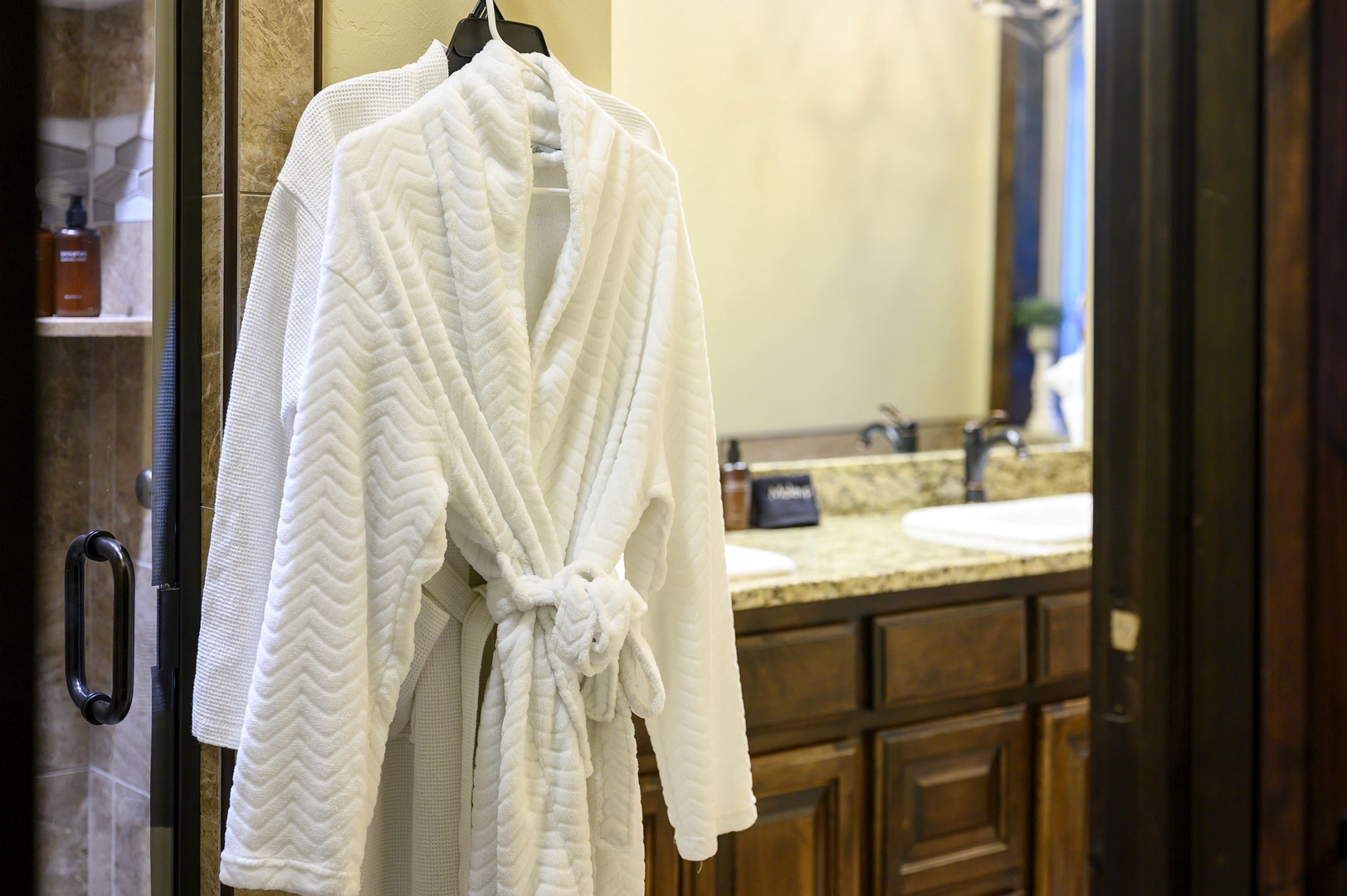 Step out of your shower and wrap yourself in a plush robe that's ready and waiting. Your private bathroom features granite counters and a warm, spa-like atmosphere.