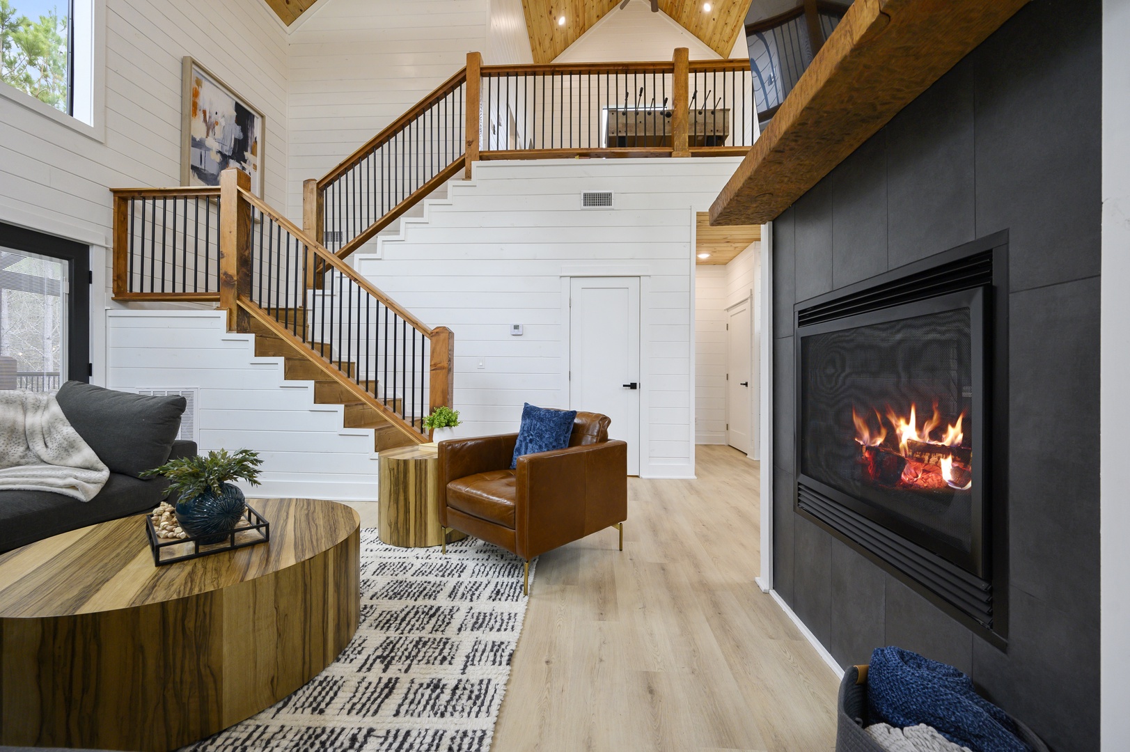 Cozy up by your private fireplace in this stylish living space, featuring warm wood accents and modern comfort for your perfect retreat.
