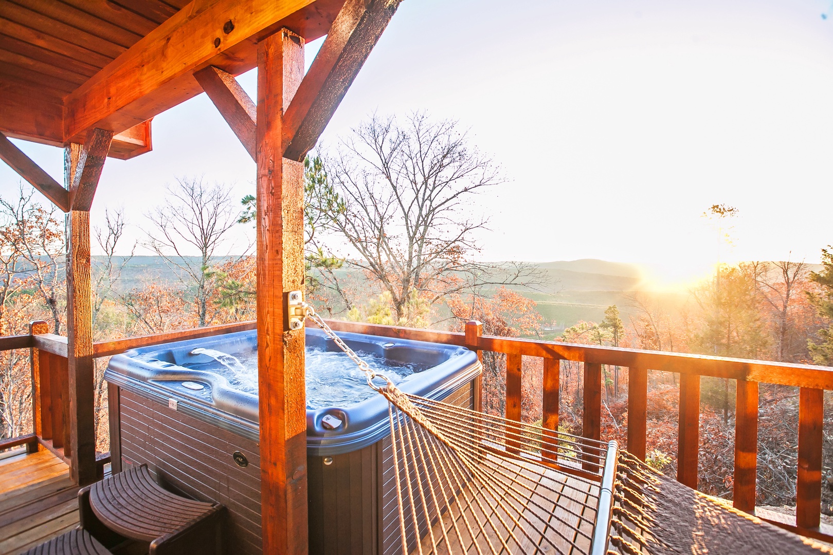 Unwind in your private hot tub while watching stunning sunsets over autumn mountains from your covered deck.