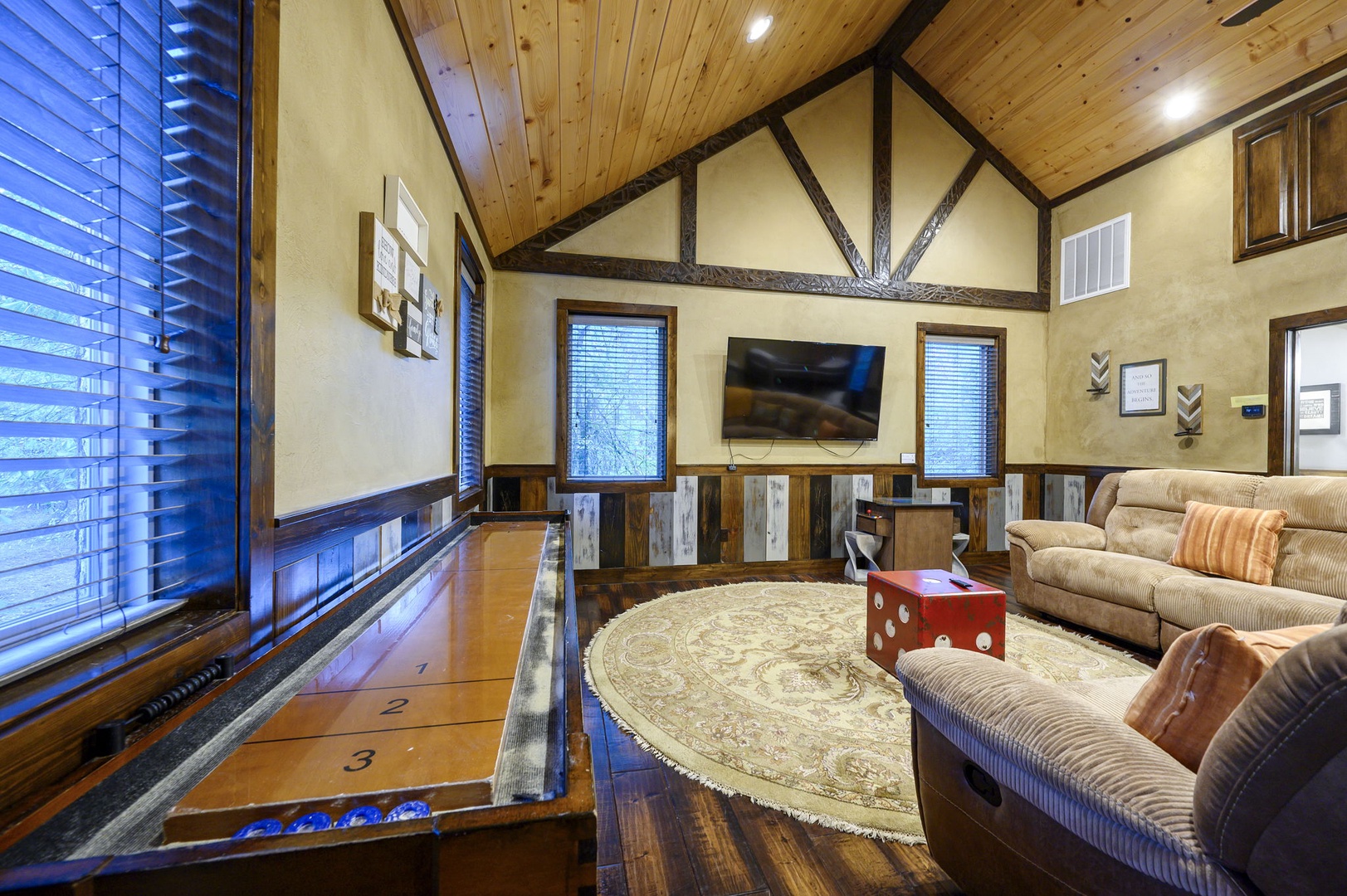 Gather here in your own cozy retreat, with soaring wood ceilings, warm rustic beams, and a unique shuffleboard built right into the floor for friendly competition and memorable nights.