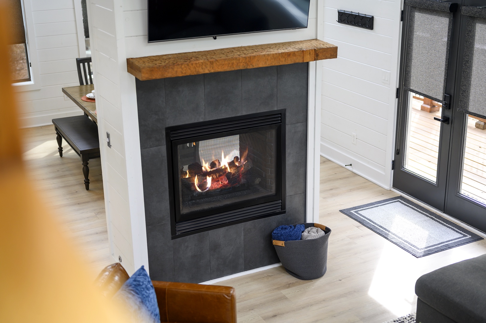 Cozy up by your crackling fireplace with its warm wood mantel and sleek slate surround, perfect for romantic evenings.