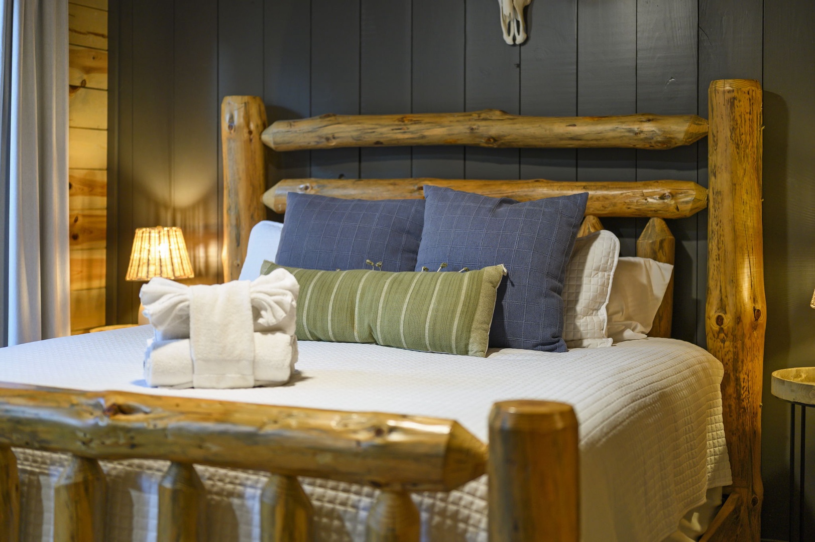 Sink into crisp linens on your rustic log-frame bed, with plush towels and cozy pillows inviting you to unwind in this charming woodland retreat.