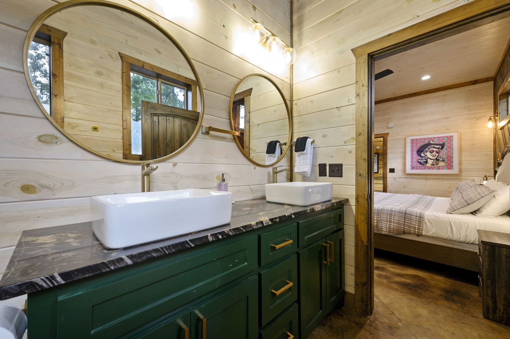 Two vessel sinks and statement mirrors create a spa-like vanity area, with your cozy bedroom just steps away.