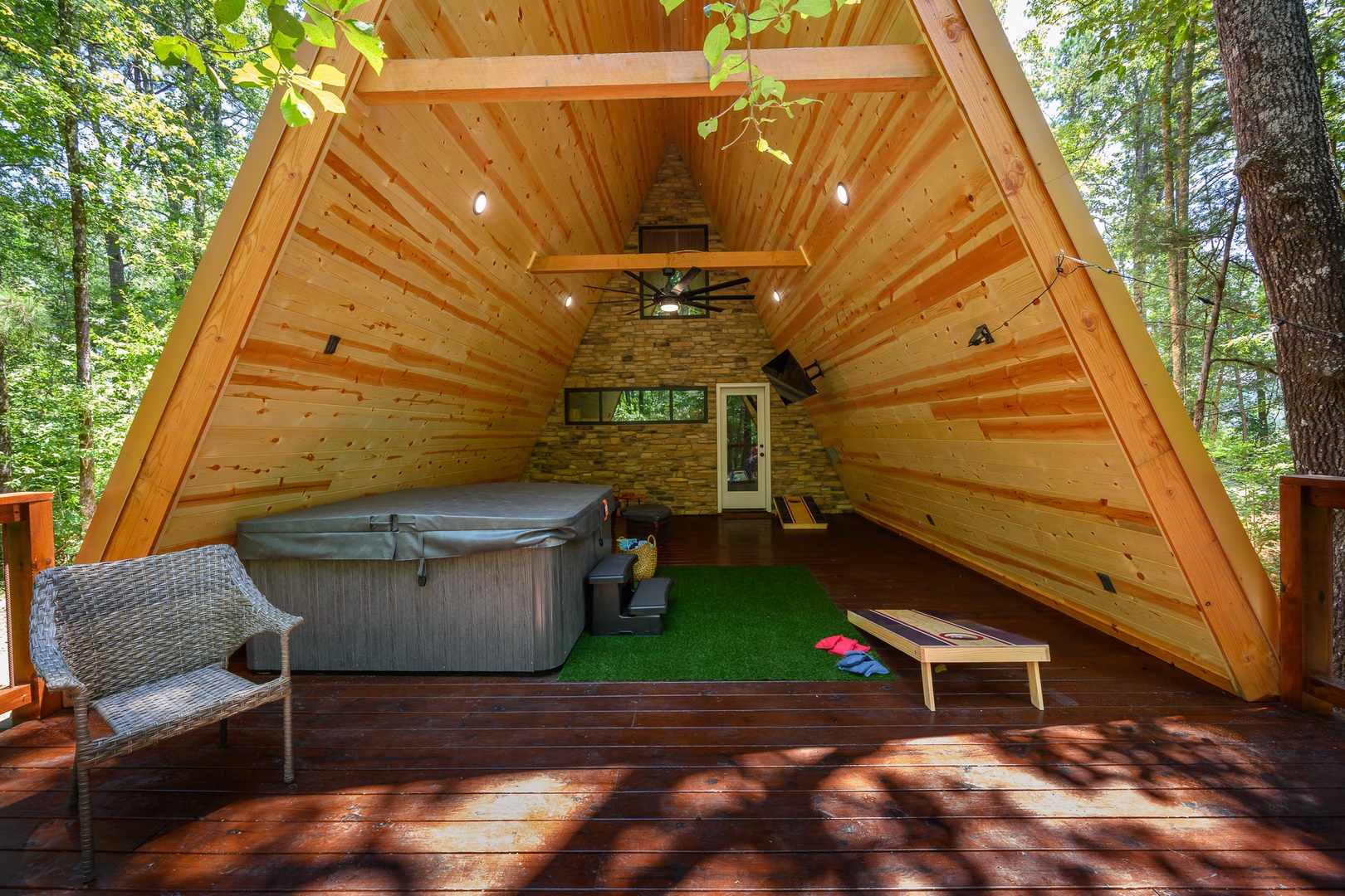 Your private A-frame retreat features a hot tub under soaring wood-beamed ceilings, surrounded by forest views. Soak, relax, and unwind in this peaceful woodland sanctuary.
