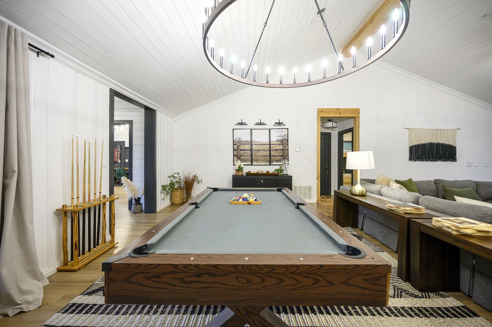 Challenge friends to billiards in your stylish game room, where modern comfort meets classic entertainment under elegant lighting.