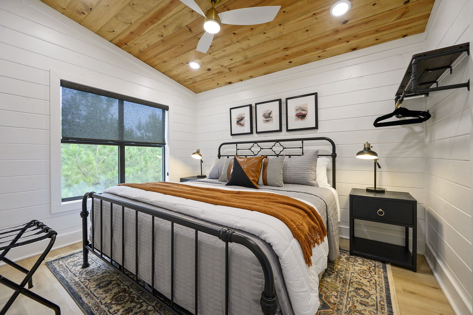 Sink into crisp linens and warm wood accents in your peaceful bedroom retreat, where natural light filters through and comfort awaits.