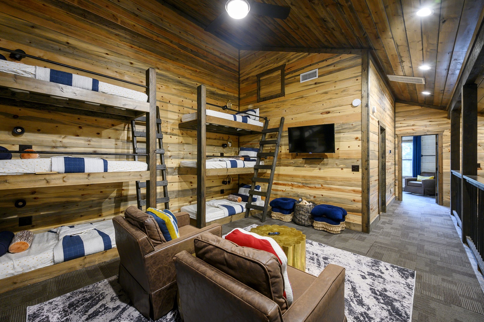 Gather in your rustic bunk room with warm wood walls, comfy leather seating, and cozy beds for everyone. The TV and ample bunks make it perfect for family nights or hanging with friends.