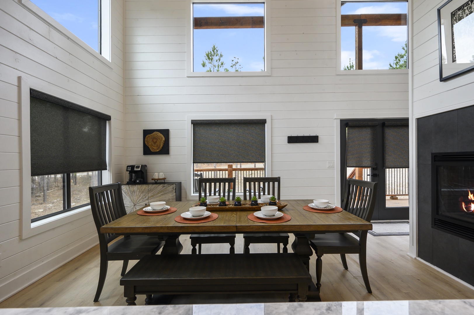 Gather around your beautifully set dining table where warm wood meets modern elegance, perfect for sharing memorable meals together.