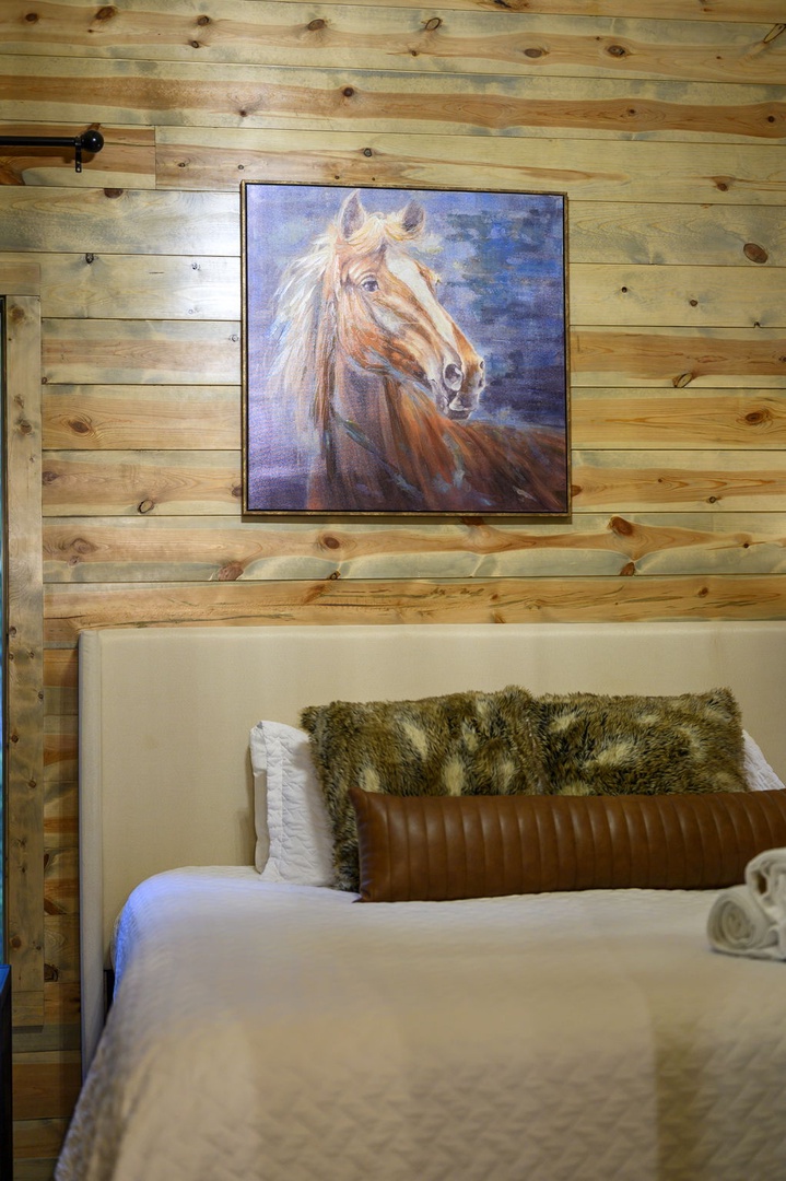 Sink into comfort beneath rustic wood-paneled walls and crisp linens, with plush faux-fur and leather accents welcoming you after a day of adventure.
