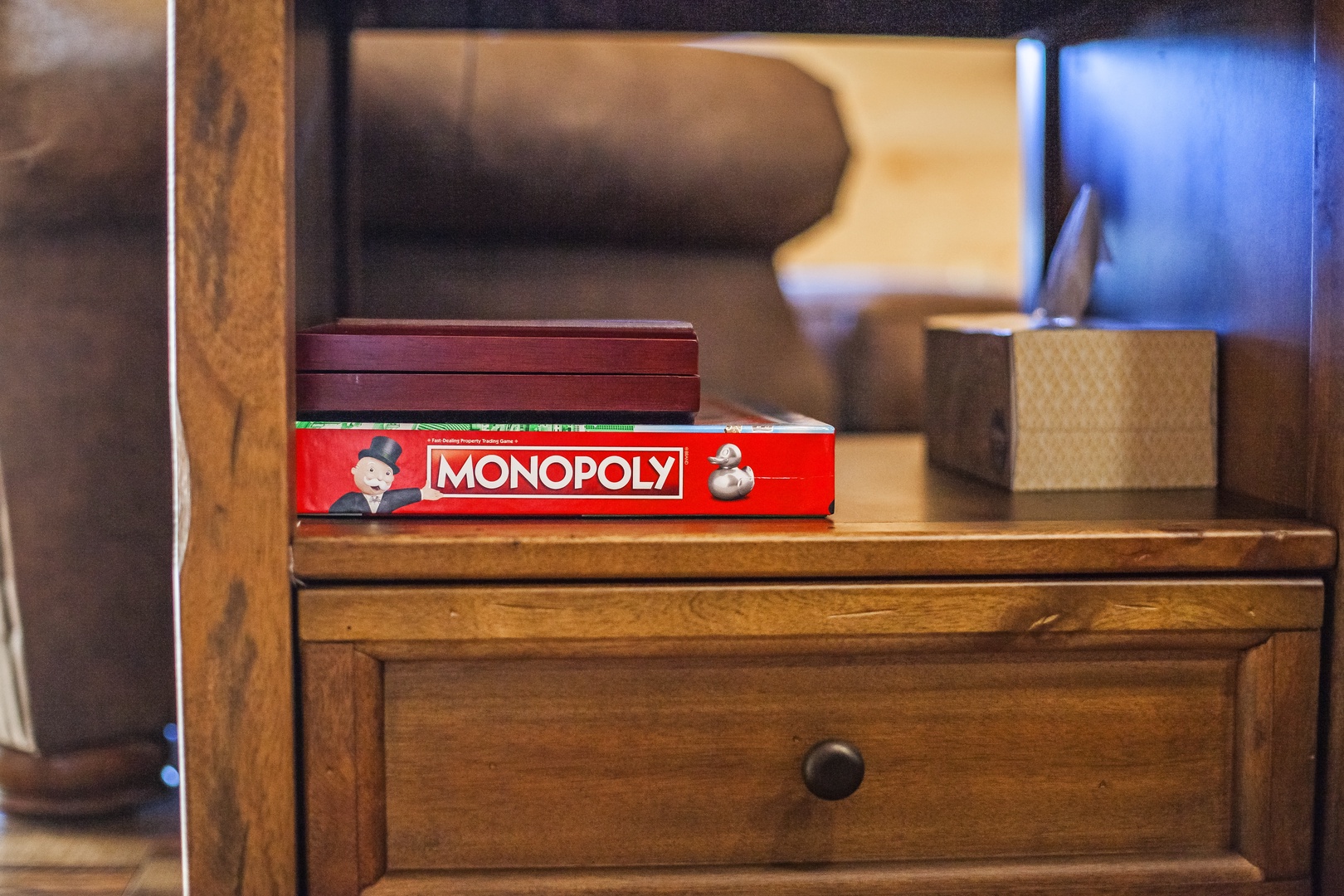 Cozy game nights await with Monopoly ready on your bedside table for those perfect rainy evening adventures together.