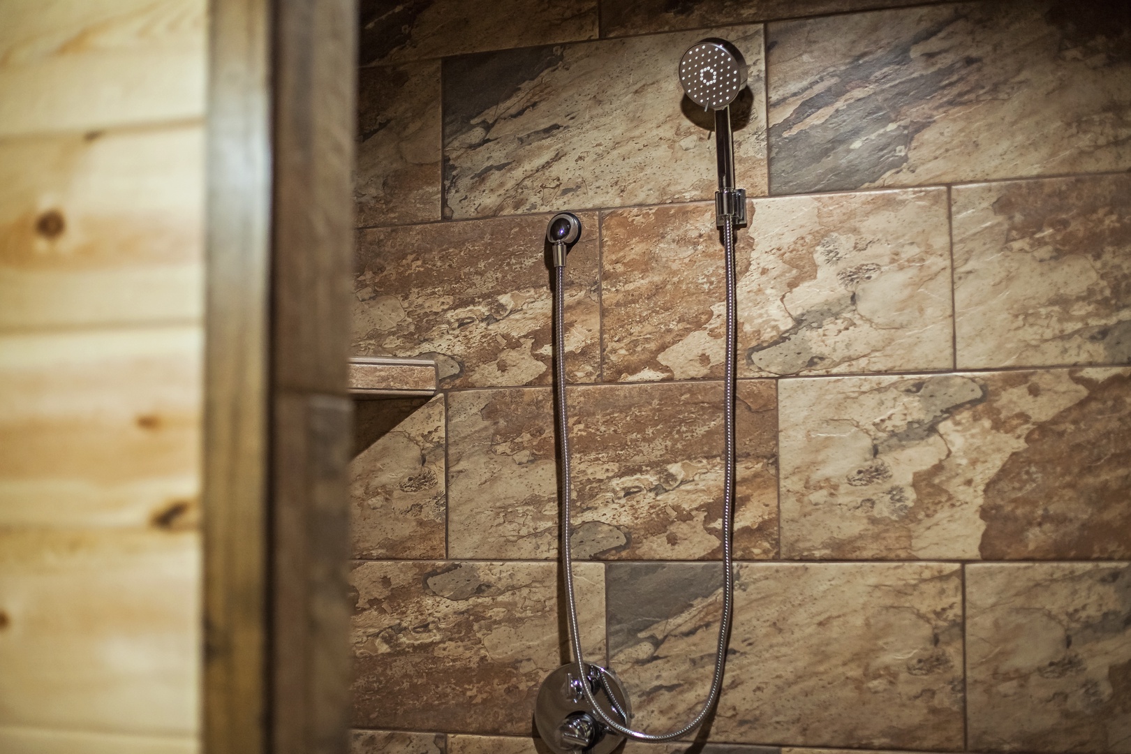 Refresh under the rainfall showerhead in your private stone-tiled sanctuary, where natural textures create a spa-like retreat.