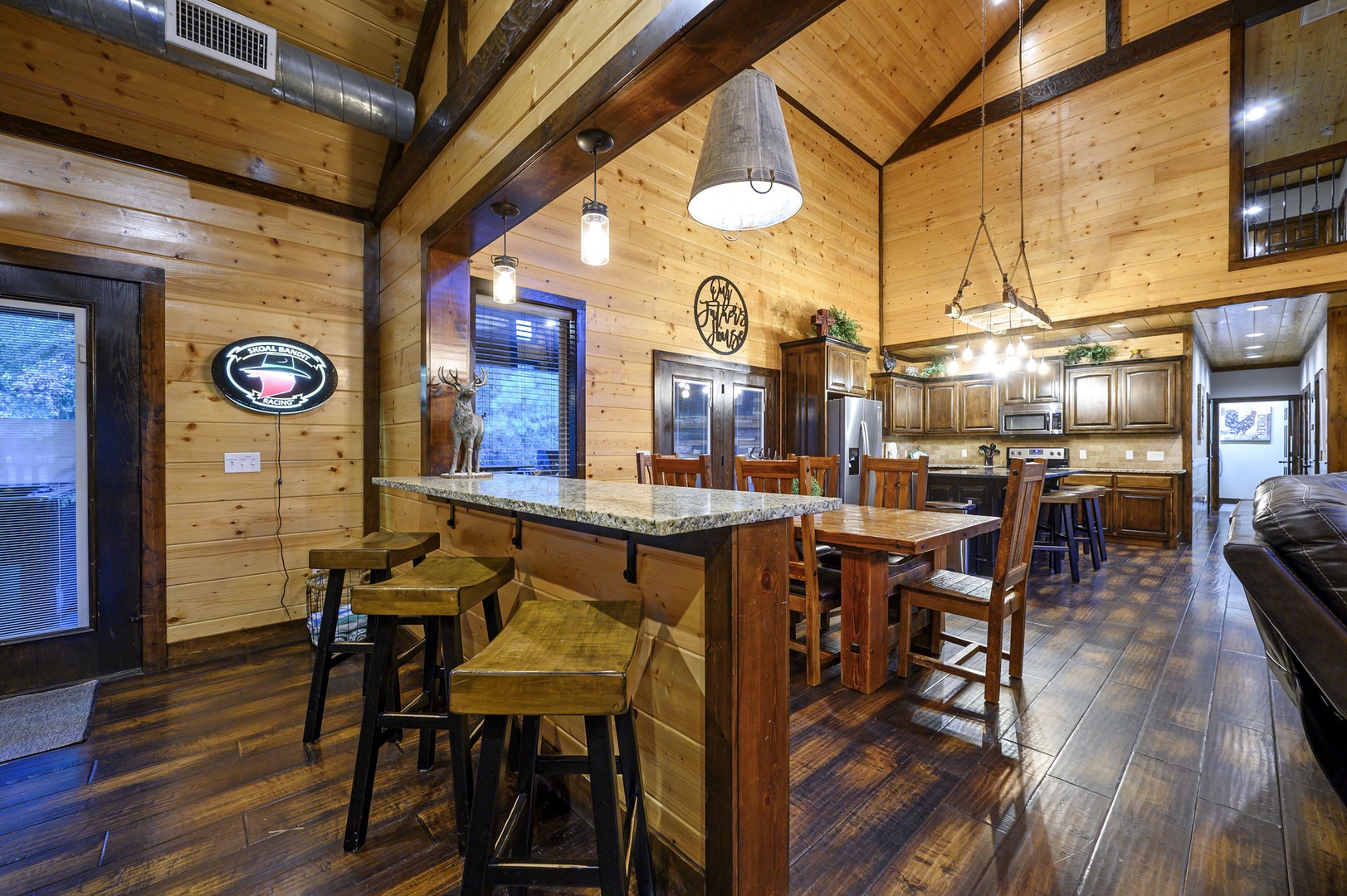 Mountain retreat with soaring vaulted ceilings and rustic wood beams. Open, light-filled kitchen and dining space perfect for gathering and sharing meals together.