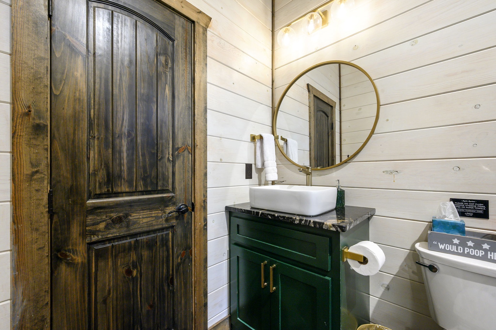 Freshen up in your own charming bathroom, complete with a modern vessel sink, rustic vanity, and warm shiplap walls that make every moment feel like a cozy retreat.