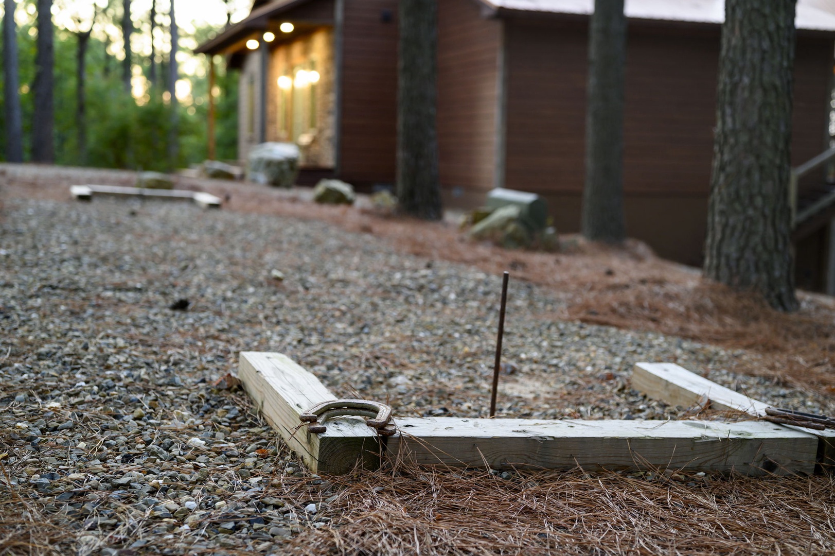 A serene forest retreat with natural surroundings and warm wooden architecture welcoming your arrival.