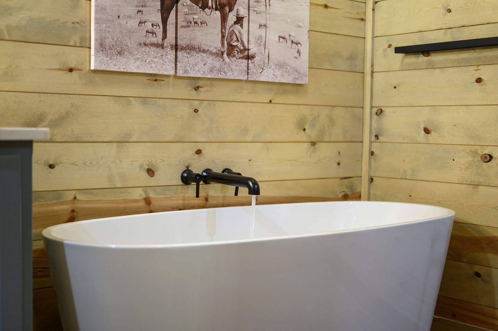 Sink into this beautiful freestanding soaking tub surrounded by warm wood paneling—your perfect retreat after a day of adventure.