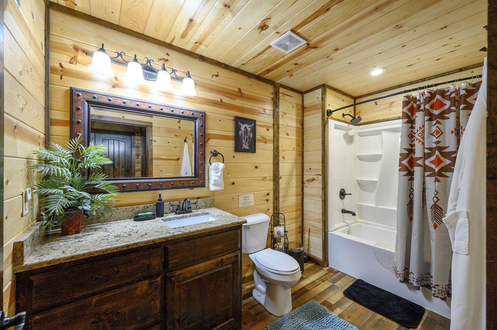 Step into your private rustic retreat with warm wood-paneled walls, modern conveniences, and thoughtful touches like a granite vanity and fresh towels waiting just for you.