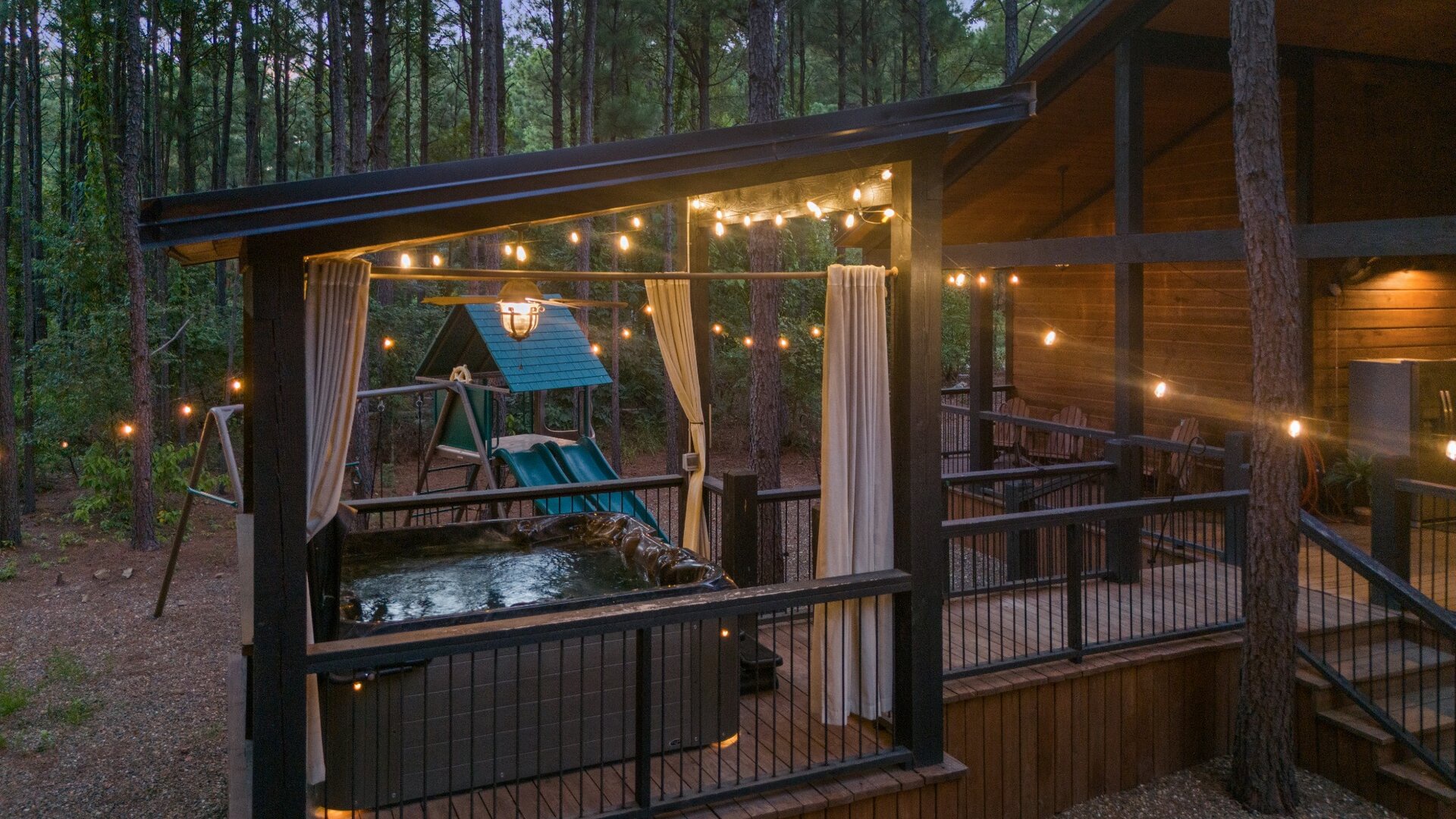 Unwind under the stars in your private hot tub, surrounded by tranquil forest views and glowing string lights. The perfect spot to soak away your cares after a day of adventure.