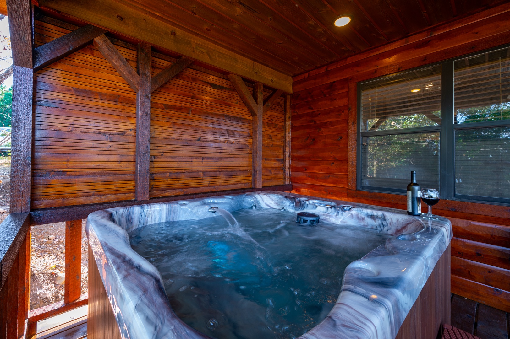 Sink into warm, bubbling waters in your private hot tub beneath rich cedar beams—perfect for unwinding after exploring.
