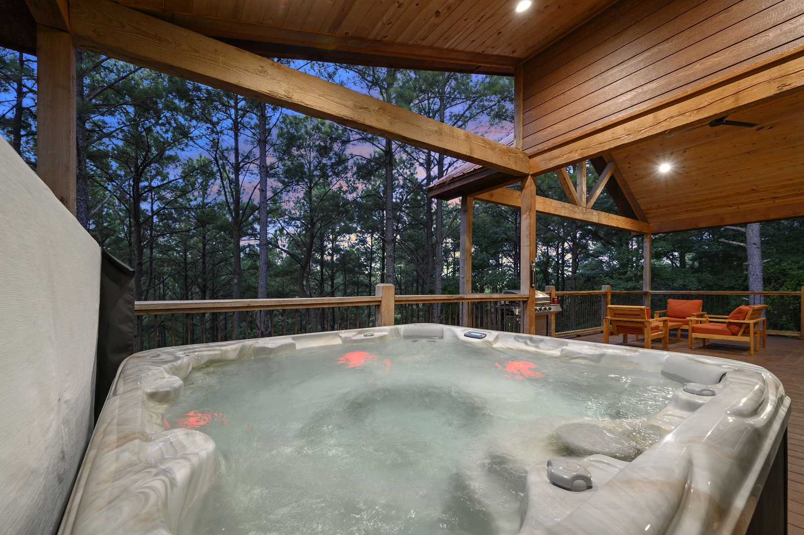 Soak away your cares in your private hot tub on this beautiful covered deck, surrounded by peaceful forest views and the gentle glow of evening skies.