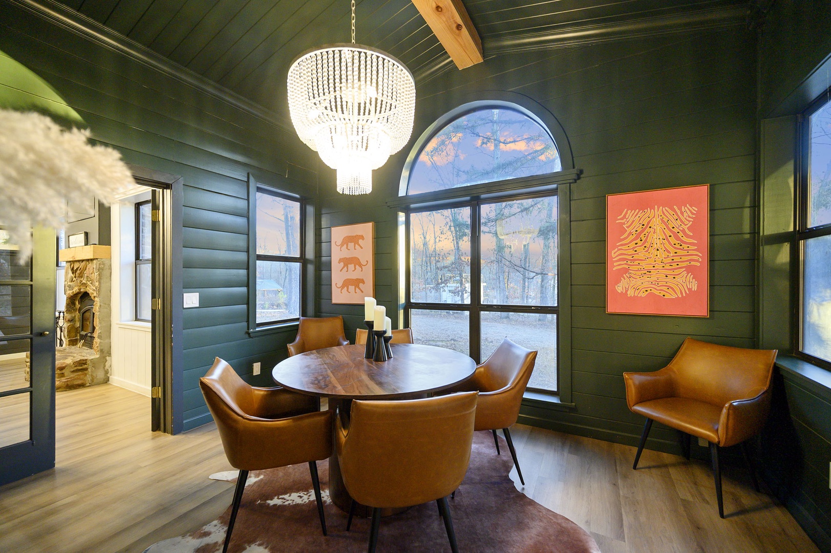 Gather around this elegant dining table with mountain views streaming through arched windows, perfect for memorable meals together.
