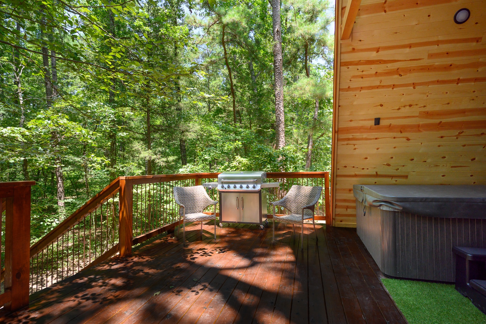 Soak in your private hot tub, grill your favorite meal, and unwind on your deck surrounded by lush forest views—your perfect wooded retreat awaits.