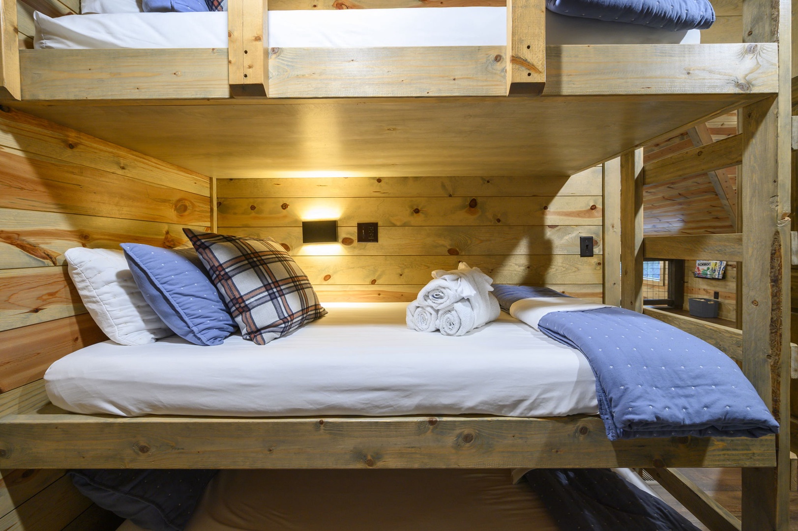 Cozy up in your charming bunk room with custom wooden beds, soft linens, and warm reading lights—perfect for peaceful mountain retreat nights.