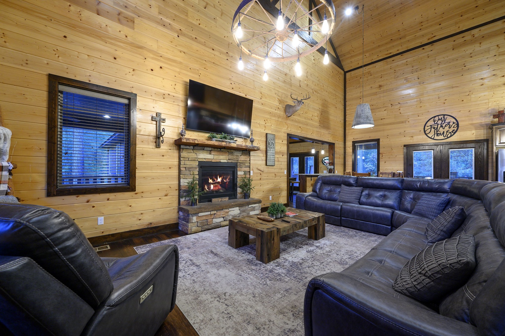 Gather by the warm fireplace with plenty of plush seating for your whole group, all under stunning custom lighting that sets a cozy, welcoming mood.