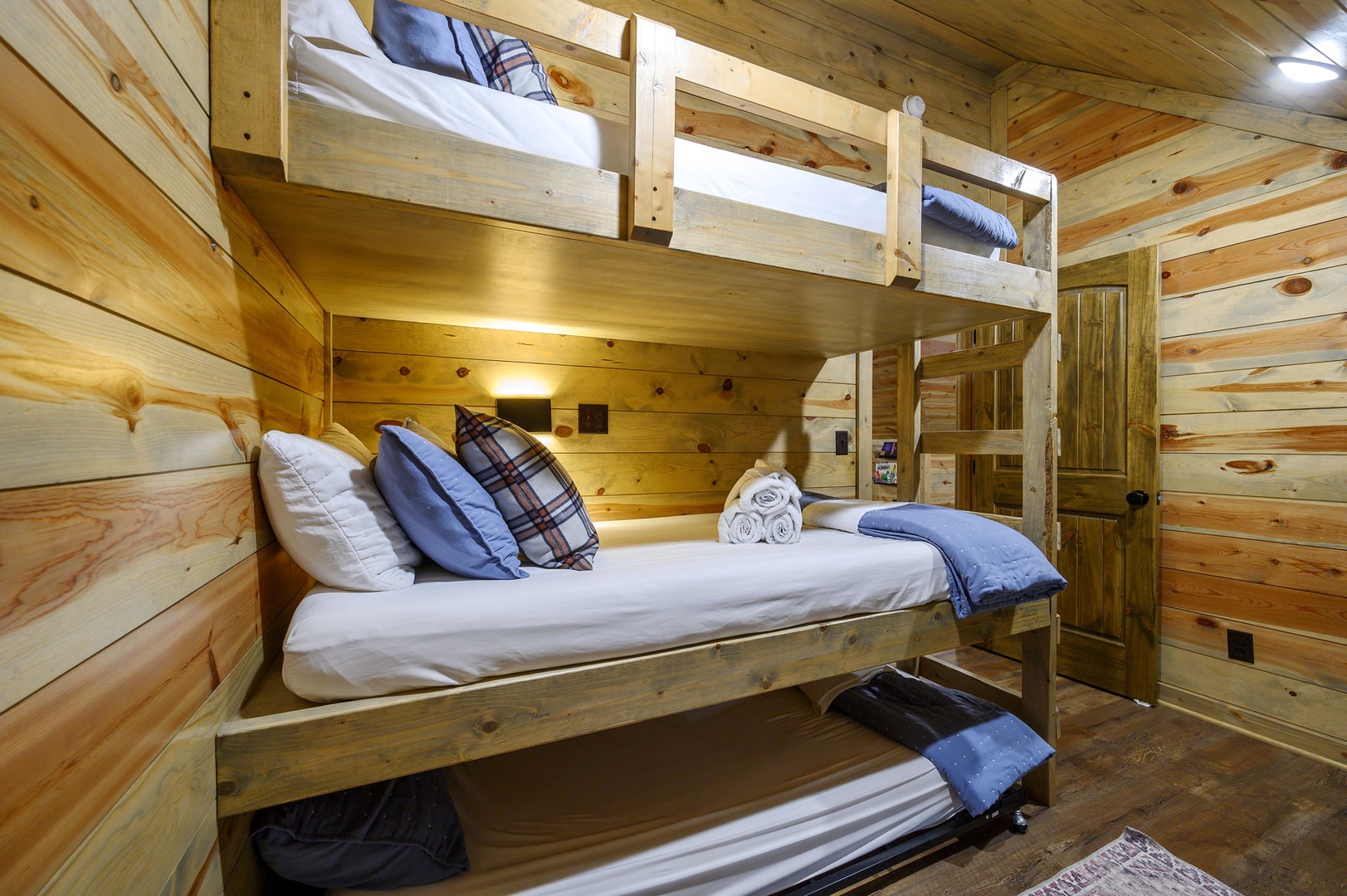Sleep soundly in your cozy cabin-style bunk room, where warm wood surrounds you and extra guests find their own comfortable retreat with fresh linens and reading lights.