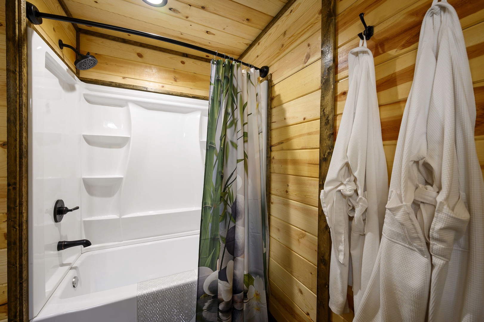 Step into your private retreat with a full tub and shower, wrapped in warm wood tones. Fresh robes await, ready for you after a relaxing soak.